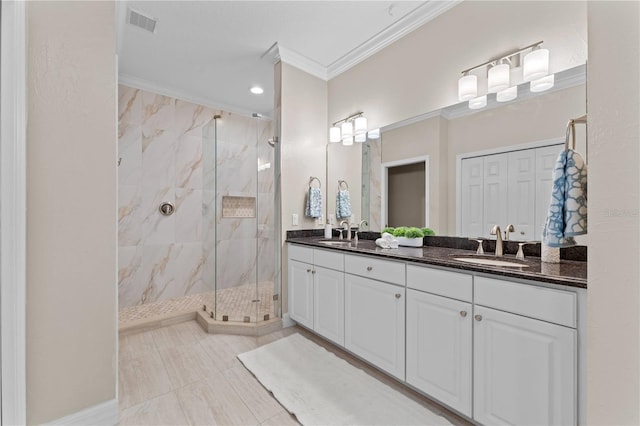 bathroom with tile patterned flooring, vanity, tiled shower, and ornamental molding