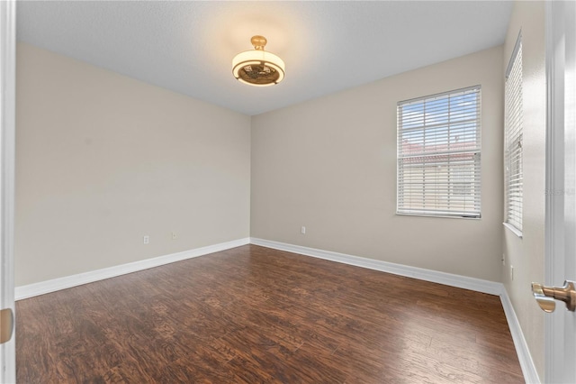 unfurnished room with dark hardwood / wood-style floors