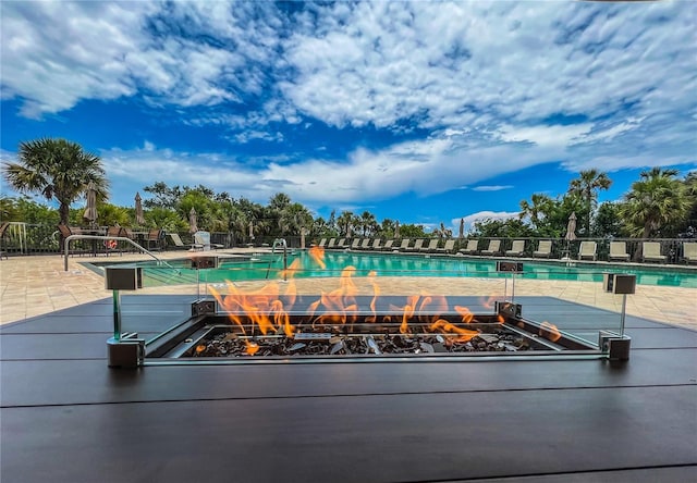 view of pool with a fire pit