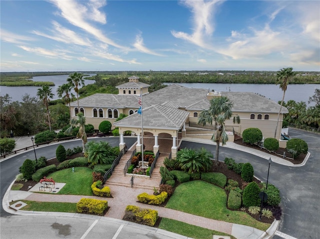 mediterranean / spanish house featuring a garage and a water view