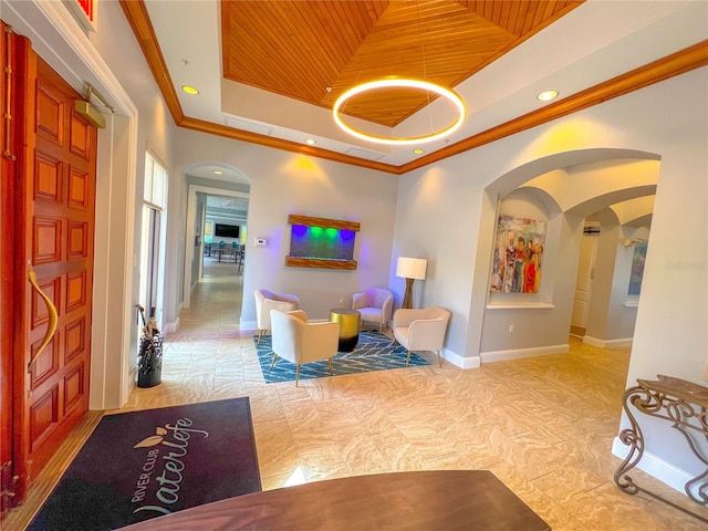 interior space featuring a tray ceiling, crown molding, and wood ceiling