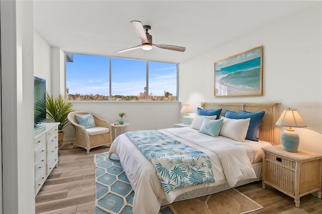 bedroom with ceiling fan and light wood-type flooring