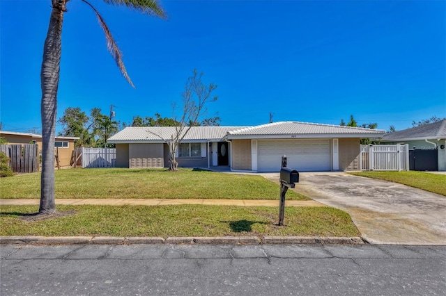 single story home featuring a garage and a front lawn