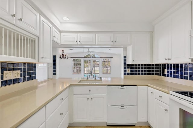 kitchen with white cabinetry, sink, and white appliances