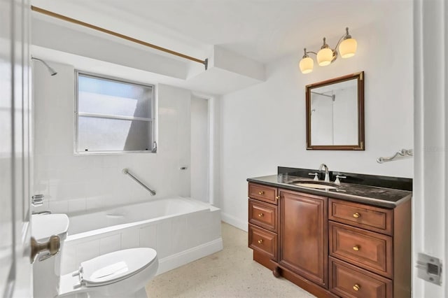 full bathroom with tiled shower / bath, vanity, and toilet