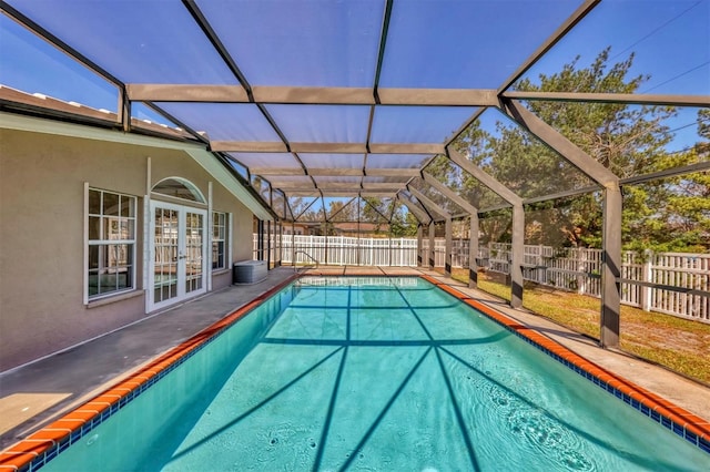 view of pool with a patio and glass enclosure