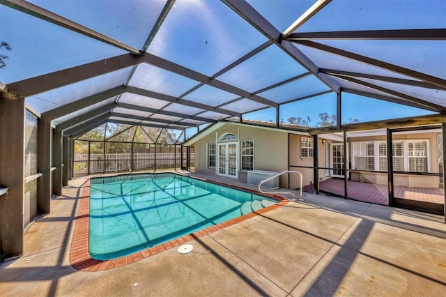 view of swimming pool with a patio and a lanai