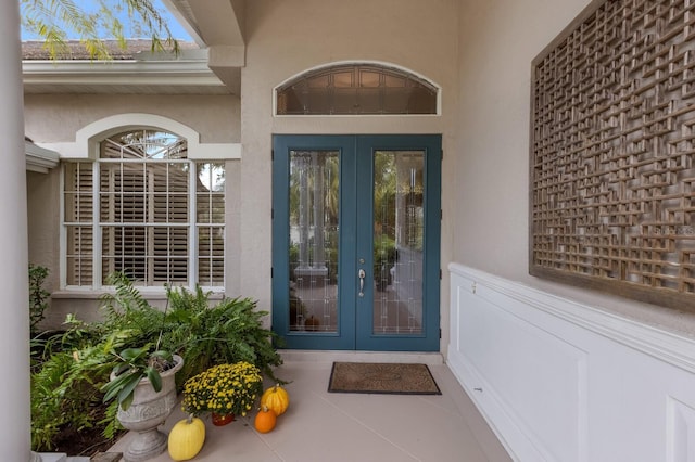 property entrance featuring french doors and stucco siding