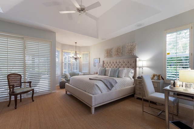 bedroom with carpet and ceiling fan with notable chandelier