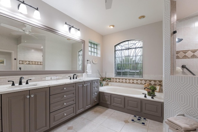 bathroom featuring tile patterned flooring, vanity, backsplash, and independent shower and bath