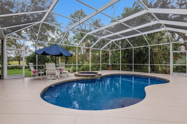 view of pool with a patio area, an in ground hot tub, and glass enclosure