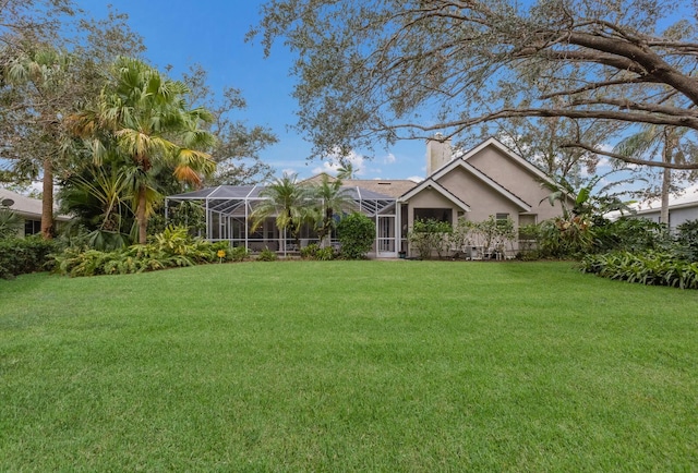 exterior space featuring glass enclosure and a front lawn