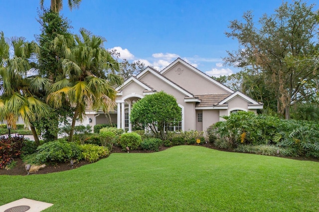 single story home with a front yard and stucco siding