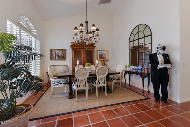 dining area featuring tile patterned flooring, high vaulted ceiling, and a chandelier