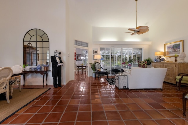 tiled living room featuring a high ceiling and ceiling fan