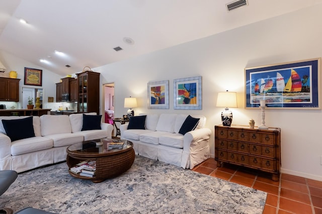 living room with tile patterned flooring, baseboards, lofted ceiling, and visible vents