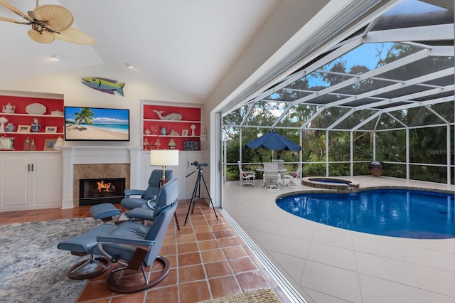 view of swimming pool with a pool with connected hot tub and a tile fireplace