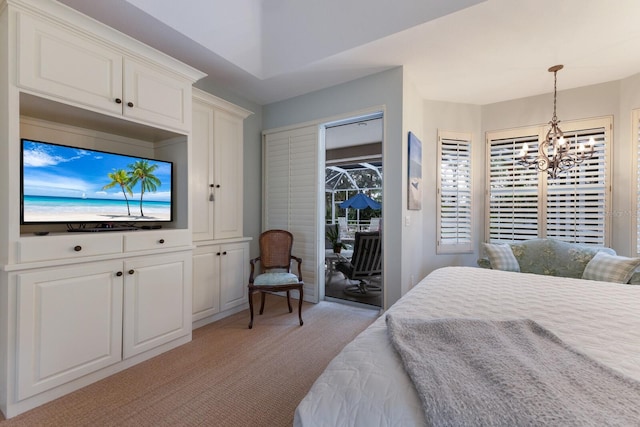 bedroom featuring access to outside, an inviting chandelier, and light carpet