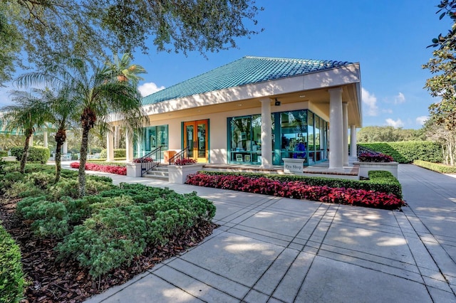 rear view of property with french doors and stucco siding