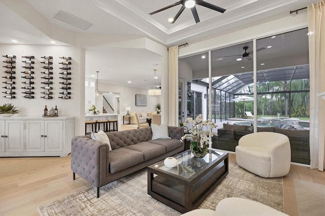 living room with ornamental molding and light wood-type flooring