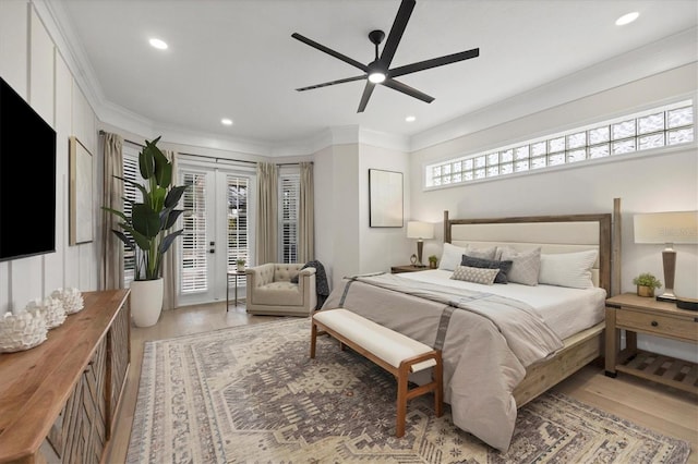 bedroom with ceiling fan, multiple windows, and light wood-type flooring