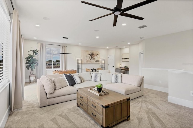 carpeted living room with ceiling fan