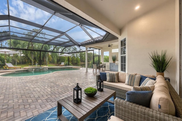 view of pool featuring ceiling fan, a patio area, glass enclosure, and an outdoor living space