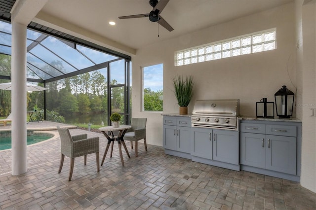 view of patio with area for grilling, ceiling fan, grilling area, and a lanai