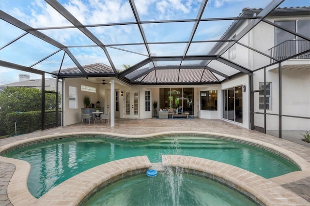 view of pool with french doors, an in ground hot tub, a lanai, a patio area, and ceiling fan