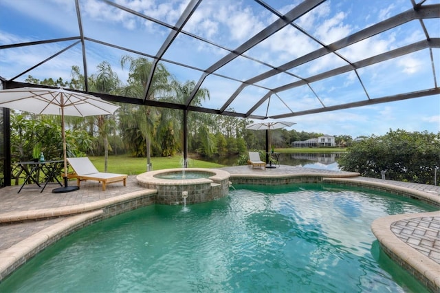 view of pool with a patio area, an in ground hot tub, a water view, and glass enclosure