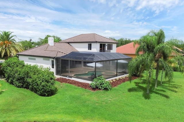 back of property with a lanai and a yard