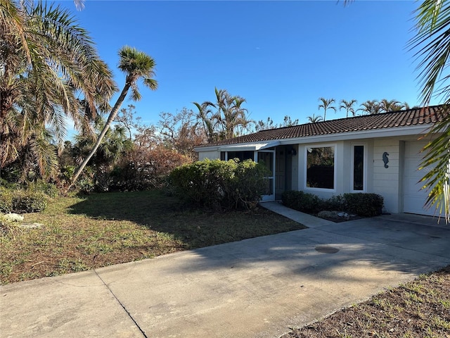 view of front of home with a front yard and a garage