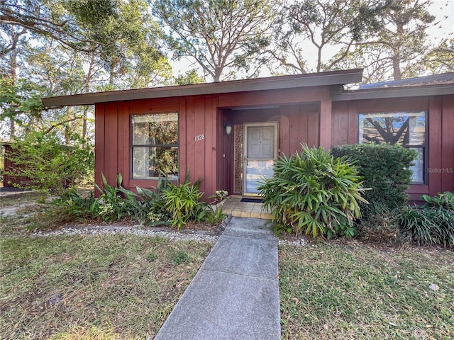 doorway to property featuring a yard