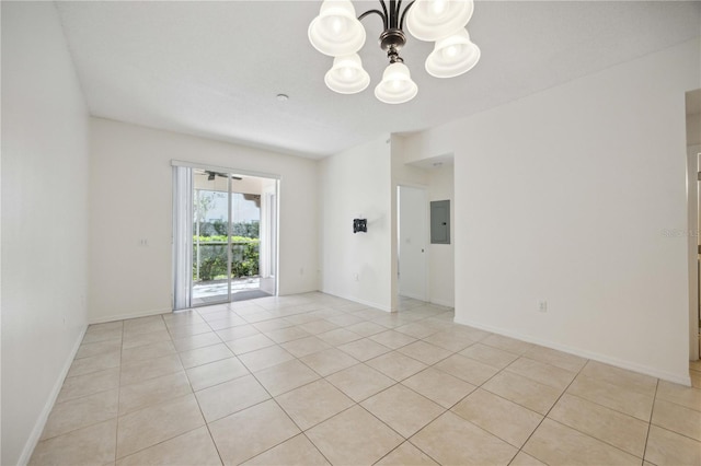 tiled spare room with electric panel and a chandelier