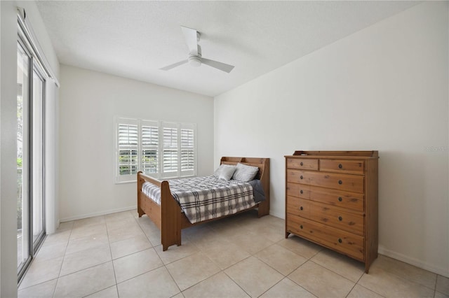 bedroom featuring access to outside, a textured ceiling, light tile patterned floors, and ceiling fan