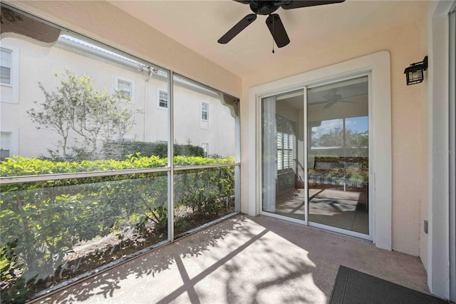 sunroom featuring ceiling fan