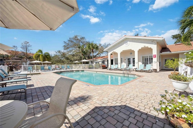 view of pool featuring french doors and a patio area