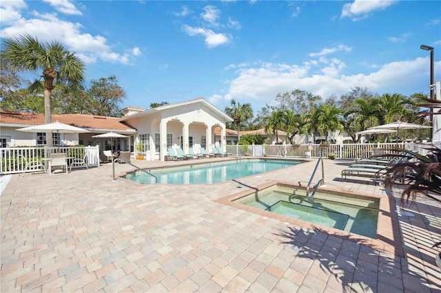 view of swimming pool with a patio area and a community hot tub