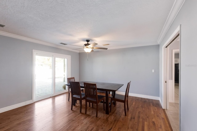 dining area featuring ornamental molding, ceiling fan, a textured ceiling, and dark hardwood / wood-style flooring