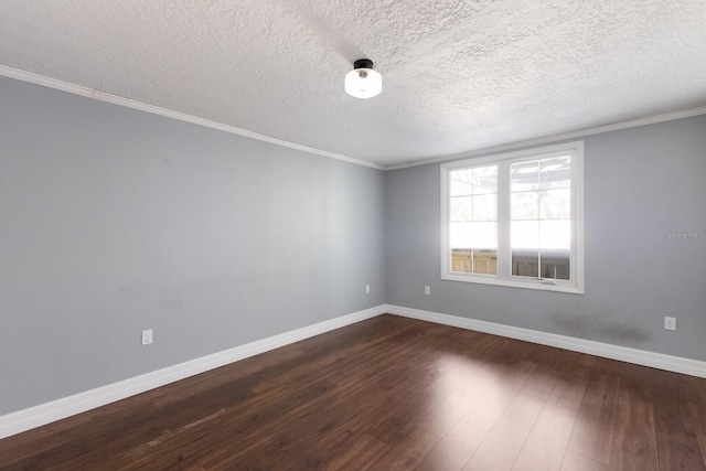 spare room with a textured ceiling, dark hardwood / wood-style flooring, and ornamental molding