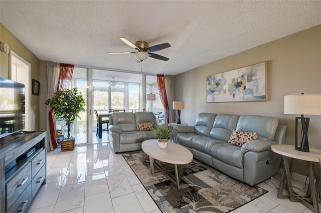 living room with a wall of windows, a textured ceiling, and ceiling fan