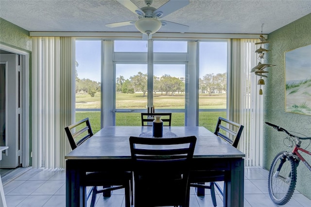 4550 Pinebrook Cir Unit 103, Bradenton, FL 34209 - dining space featuring a ceiling fan, a textured wall, a textured ceiling, and light tile patterned flooring