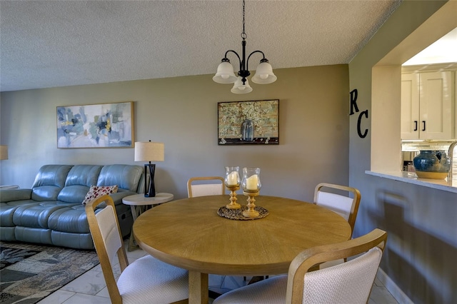 dining area featuring a notable chandelier and a textured ceiling