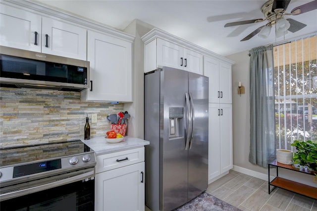 4550 Pinebrook Cir Unit 103, Bradenton, FL 34209 - kitchen featuring ceiling fan, decorative backsplash, baseboards, stainless steel appliances, and white cabinetry