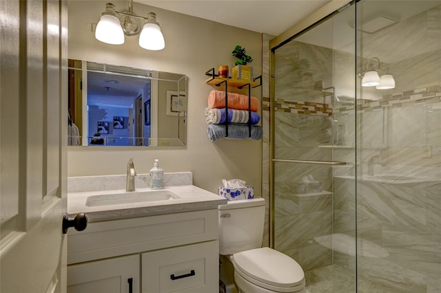 bathroom with vanity, a shower with shower door, and toilet