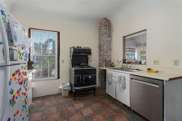 kitchen featuring sink, dishwasher, plenty of natural light, and white refrigerator