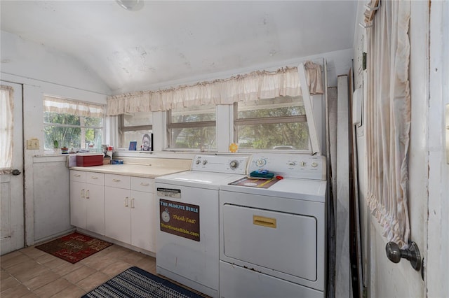 clothes washing area with light tile patterned floors, cabinets, and separate washer and dryer