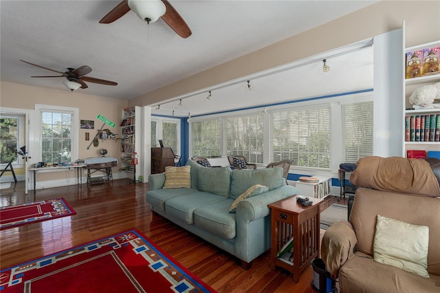 living room with dark hardwood / wood-style floors, ceiling fan, a textured ceiling, and rail lighting