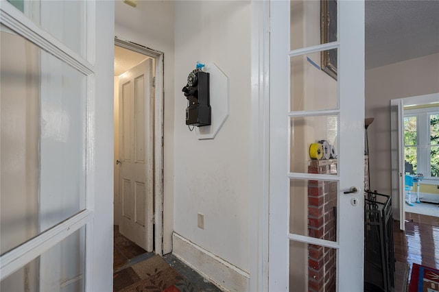 corridor featuring dark hardwood / wood-style flooring