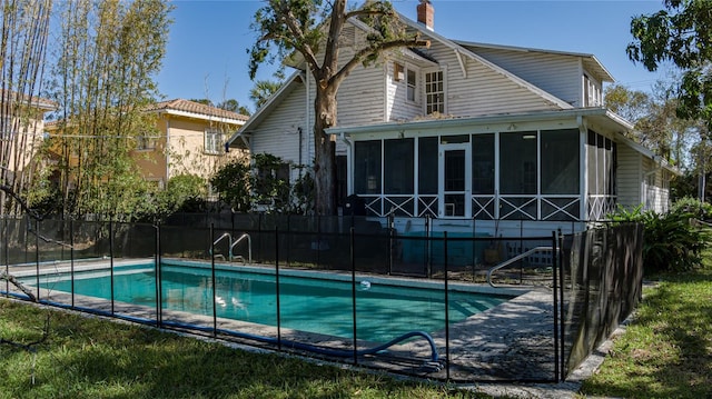 view of swimming pool featuring a sunroom